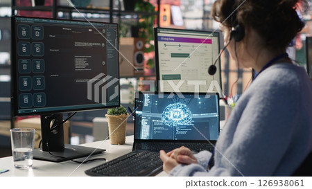 Worker providing live chat support, typing on keyboard, using AI chatbot to handle clients complaints. Call center agent dealing with unsatisfied customers using artificial intelligence LLM, camera A 126938061