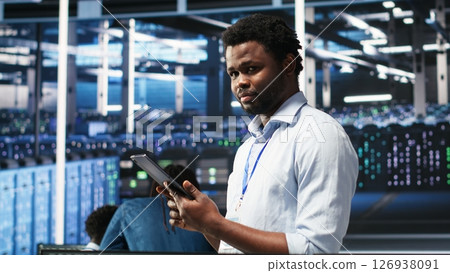 Data center technician uses node tree programming interface to identify equipment performance issues. Engineer reviews data analysis graph in server hub to minimize hardware failures, camera B Data center technician uses node tree programming interface to identify equipment performance issues. Engineer reviews data analysis graph in server hub to minimize hardware failures, camera B 126938091