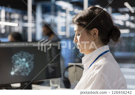 Data center computer scientist analyzing software logs metrics on PC monitor, optimizing systems. Close up of woman in server farm inspecting resource utilization, managing application efficiency Data center computer scientist analyzing software logs metrics on PC monitor, optimizing systems. Close up of woman in server farm inspecting resource utilization, managing application efficiency 126938242