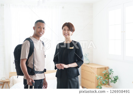 Asian hotel staff and foreign tourists Asian hotel staff and foreign tourists 126938491