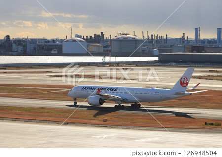 Passenger plane heading to the runway Departure image JAL 126938504