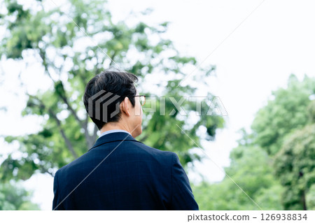 Middle-aged man walking outdoors 126938834