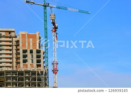 Construction industry.New building.Large high rise cranes 126939185