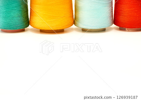 Four colored spools of thread.Tailoring supplies 126939187