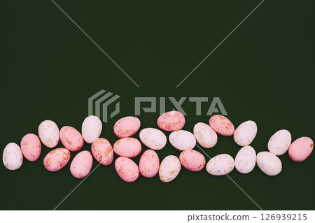 Scattered pink eggs circles for decoration on black 126939215