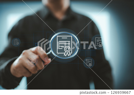 Magnifying glass icon focused on digital certification paper and seal for quality verification concept 126939667