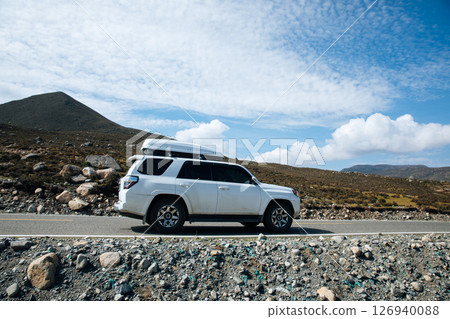 Sichuan,China - August 25,2024 ,Driving Toyota off road car on the high altitude grassland mountains 126940088