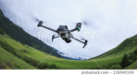 Drone flying on high altitude mountain top 126940104
