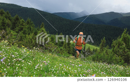 Hiker hiking on high altitude mountain top 126940106