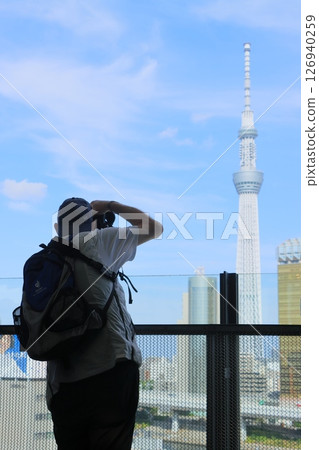 A man taking a photo of the Skytree, sightseeing in Asakusa A man taking a photo of the Skytree, sightseeing in Asakusa 126940259
