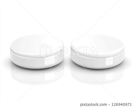 Two white round cosmetic containers with lids on a surface Two white round cosmetic containers with lids on a surface 126940971