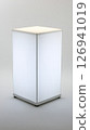 Lit cube stands upright in a neutral colored background 126941019