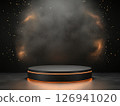 A dark circular platform surrounded by orange glitter dust 126941020