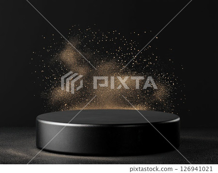 Black circular platform with golden powder against a dark background 126941021