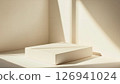 Beige platform in corner illuminated by natural sunlight streams 126941024