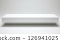Rectangular white platform casting shadow on an empty white background 126941025
