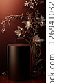 Black pedestal with golden floral design against maroon background 126941032