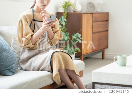 A woman troubled while watching a smartphone 126941345