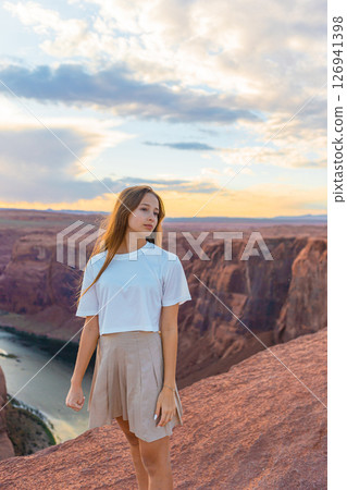 Happy girl on the edge of the cliff at Horseshoe Band Canyon in Page, Arizona. Adventure and tourism concept. Beautiful nature in USA 126941398
