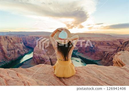 Beautiful woman in yellow dress on the edge of the cliff at Horseshoe Band Canyon in Paje, Arizona. Beautiful nature in USA Beautiful woman in yellow dress on the edge of the cliff at Horseshoe Band Canyon in Paje, Arizona. Beautiful nature in USA 126941406
