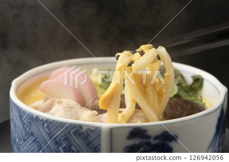 Picking up steamed odamaki rolls with chopsticks 126942056