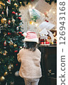 Child looking at Christmas tree 126943168