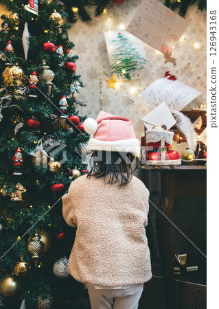 Child looking at Christmas tree 126943168