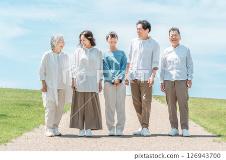 A happy family on a hill with a road, family, parents and children, three-generation family A happy family on a hill with a road, family, parents and children, three-generation family 126943700