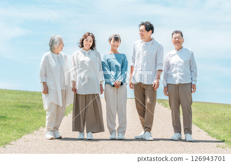A happy family on a hill with a road, family, parents and children, three-generation family A happy family on a hill with a road, family, parents and children, three-generation family 126943701