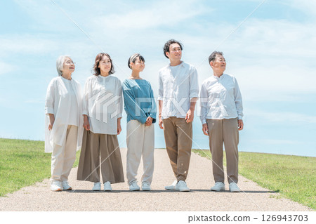 A happy family on a hill with a road, family, parents and children, three-generation family 126943703