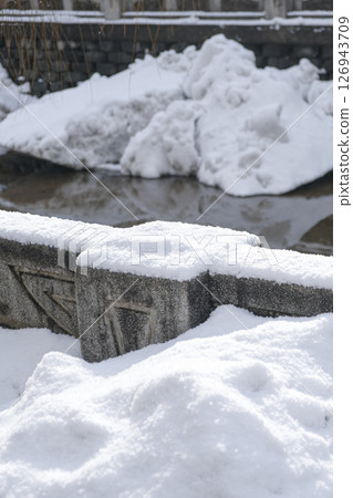 Snow piled up along the river 126943709