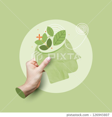 Mental health concept. hand holding a head with growing leaves, representing mental growth, cultivating the mind, healthy mind. cognitive function and mental clarity on green background. 126943807
