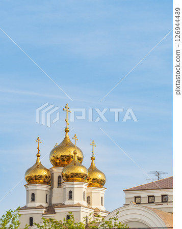 The golden domes of the Christian church in sunset light. The golden domes of the Christian church in sunset light. 126944489