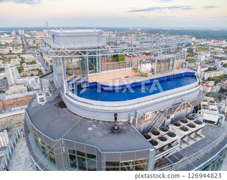 Aerial view of the Yekaterinburg city center with Vysotsky skyscraper. Beautiful landscape of a high-rise building with a rooftop pool and glass facade in Russia Aerial view of the Yekaterinburg city center with Vysotsky skyscraper. Beautiful landscape of a high-rise building with a rooftop pool and glass facade in Russia 126944823