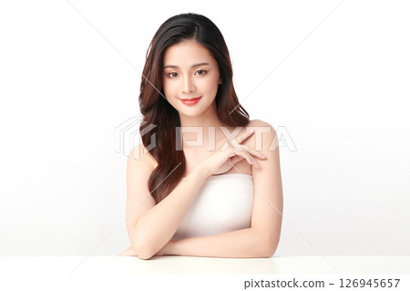 A beautiful young Asian woman with clean, fresh skin against a white background. Skincare, facial treatment, cosmetology, beauty, and spa. An elegant portrait of an Asian woman. A beautiful young Asian woman with clean, fresh skin against a white background. Skincare, facial treatment, cosmetology, beauty, and spa. An elegant portrait of an Asian woman. 126945657