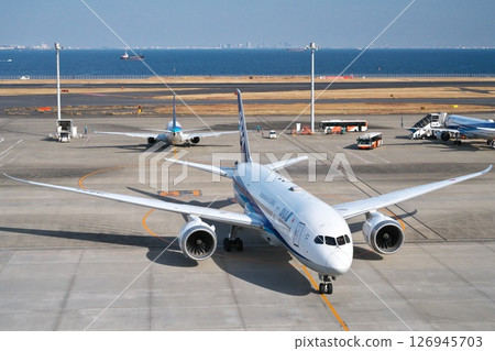 ANA passenger plane parked at Haneda Airport Runway C Terminal 2 and Tokyo Bay 126945703