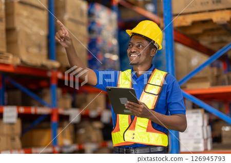 African American man working in warehouse using tablet for stock checking counting stock at shelf 126945793