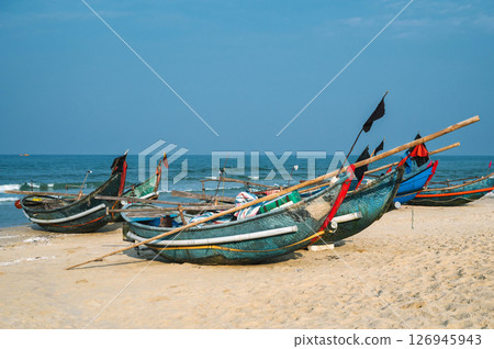 Traditional wooden Vietnamese boats on the beach by sea in a fishing village in Vietnam Traditional wooden Vietnamese boats on the beach by sea in a fishing village in Vietnam 126945943