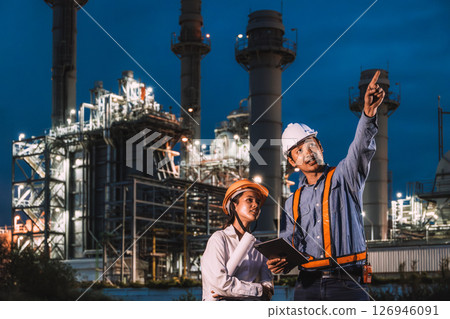 Engineer worker team night working against petroleum gas turbine power plant, Night shift survey inspector outdoor 126946091