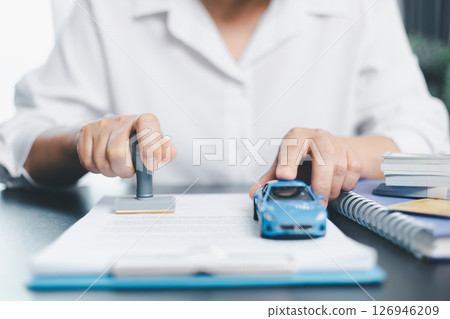 Businesswoman hand stamp approve on financial business approval document paper. Man hand accept permit contract agreement. Broker manager sign contract bank guarantee approved stamp application form 126946209