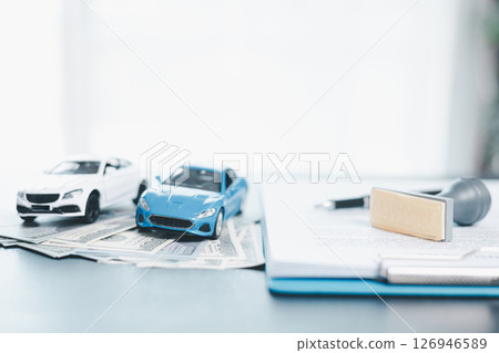 Approved car loan application with car key, rubber stamp and calculator concept. financial document on wooden table. Asset approval purchases to buy car. Ideas for car buying checklist loan tax 126946589