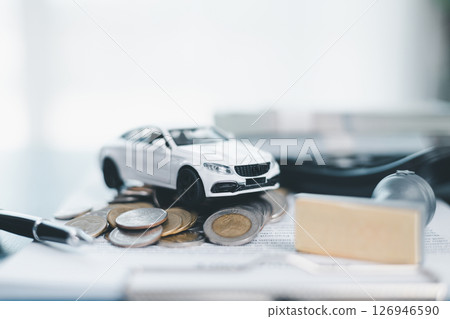 Approved car loan application with car key, rubber stamp and calculator concept. financial document on wooden table. Asset approval purchases to buy car. Ideas for car buying checklist loan tax 126946590