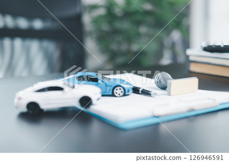 Approved car loan application with car key, rubber stamp and calculator concept. financial document on wooden table. Asset approval purchases to buy car. Ideas for car buying checklist loan tax 126946591