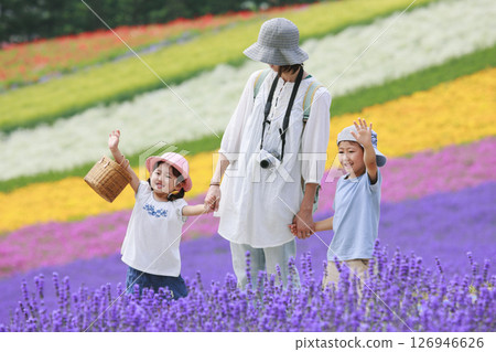 Brother and sister and their mother waving in a lavender field 126946626