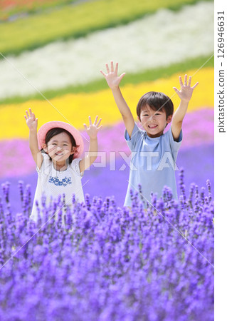 Brother and sister waving in a lavender field Brother and sister waving in a lavender field 126946631