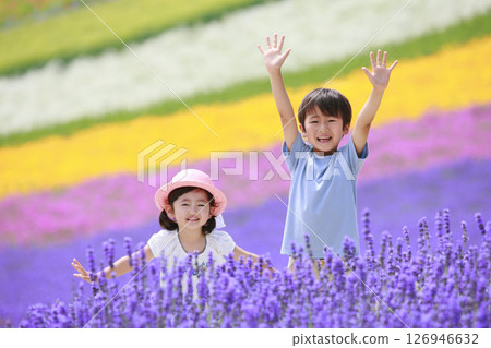 Brother and sister waving in a lavender field Brother and sister waving in a lavender field 126946632