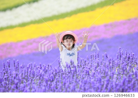 Girl waving in a lavender field Girl waving in a lavender field 126946633