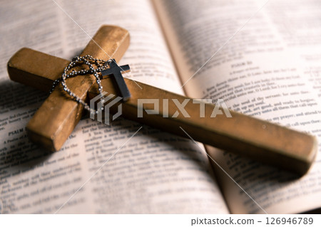 Religious belief concept Close up prayer Christian church service Bible Holy cross Spiritual power Blurred background Desk copy space Heaven God Catholic faith Praise book Jesus worship Gospel symbols 126946789