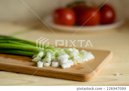 Green onions on a kitchen board 126947099