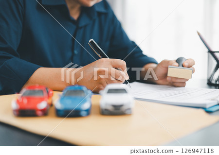 Businesswoman hand stamp approve on financial business approval document paper. Man hand accept permit contract agreement. Broker manager sign contract bank guarantee approved stamp application form 126947118